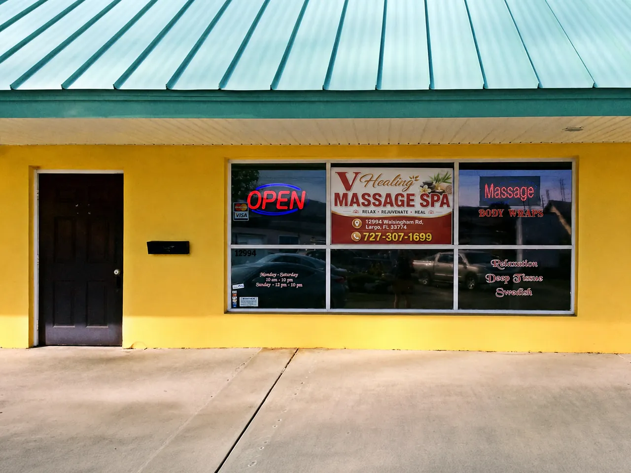 Storefront of V Healing Massage Spa on Walsingham Rd in Largo, FL, with the V Healing Massage Spa sign in the window