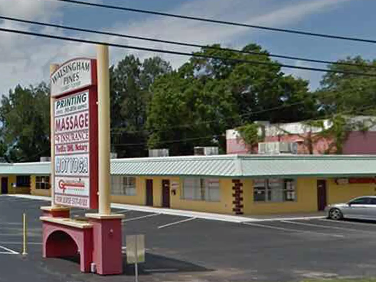 The Walsingham Pines plaza sign with MASSAGE on it, outside V Healing Massage Spa on Walsingham Rd in Largo, FL